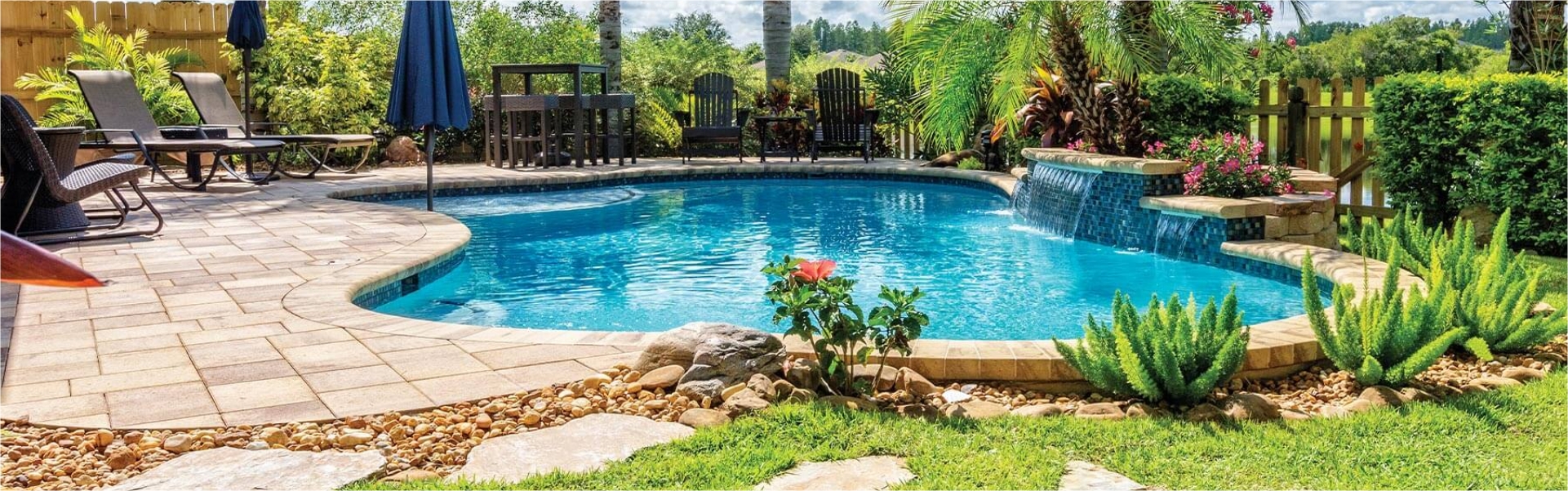 Backyard swimming pool with fountain and patio furniture